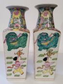 A pair of early 20th century Chinese porcelain Famille Rose vases of tapering square sectional form,