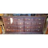 A substantial bank of ten haberdashery drawers, brass batwing escutcheons with drop swing handles,