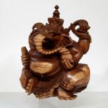 A 20th century carved wood sculpture of the Hindu god Ganesha, India. 26cm high x 27cm wide