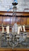 A French gilt metal chandelier with central frosted glass torch / flame finial, showing signs of