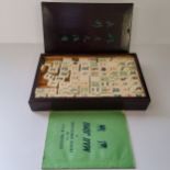 A complete Chinese bamboo and bone cased Mah Jong set, with instuctions & rule book. 20th century.