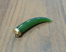 A 9ct gold mounted jade tusk pendant, 6cm long, 10.2g gross