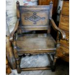 A 17th century style country house hall chair, ecclesiastical in taste. Carved panel back c.1880