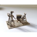 A Dutch silver miniature of street seller & young boy on machine turned rectangular base, J.