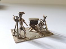 A Dutch silver miniature of street seller & young boy on machine turned rectangular base, J.