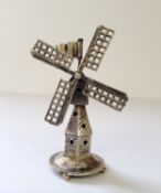 A Dutch silver miniature of tower windmill, on a circular base raised on four bun feet, J. Verhoogt,