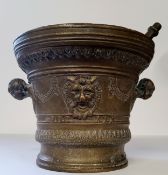 A substantial 17th century style continental bronze pestle & mortar, the mortar of flared circular