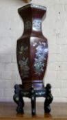 A large 'Meiji period' Japanese lacquered octagonal temple vase, each panel profusely inlaid with