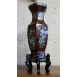 A large 'Meiji period' Japanese lacquered octagonal temple vase, each panel profusely inlaid with