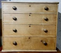 A Victorian farmhouse pine chest of four graduated drawers, turned handles, lacking bun feet, C.