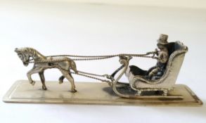 A Dutch silver miniature of a horse drawn sleigh & driver, stamped XXX & sword mark 23.1g