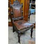 A 19th century oak and leather country house hall chair, castors c.1880