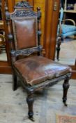 A 19th century oak and leather country house hall chair, castors c.1880
