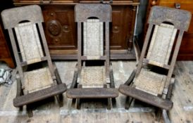 A well carved set of three Burmese chairs, each carved with unique designs including one with the