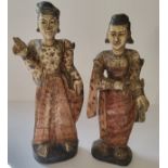 A near pair of Oriental polychrome painted carved wood figures of lady's of title, standing 36cm