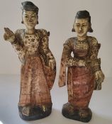 A near pair of Oriental polychrome painted carved wood figures of lady's of title, standing 36cm