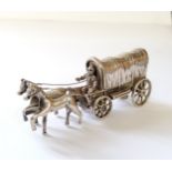 A continental white miniature of a horse drawn conestoga wagon with driver, indistinct marks 50.11g