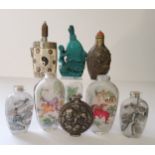 Nine Oriental snuff bottles, including a turquoise coloured carp and lilly pad example, white