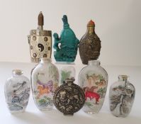 Nine Oriental snuff bottles, including a turquoise coloured carp and lilly pad example, white