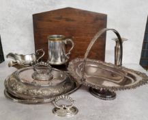 A silverplated swing handled pedesstal fruit basket, the rim decorated in relief with scrolls &