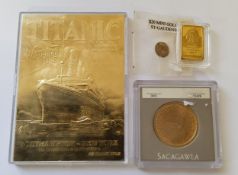 A US Sacagawea 2000 $1 dollar coin; miniature St Gaudens yellow metal replica $20 coin; a 5 grams