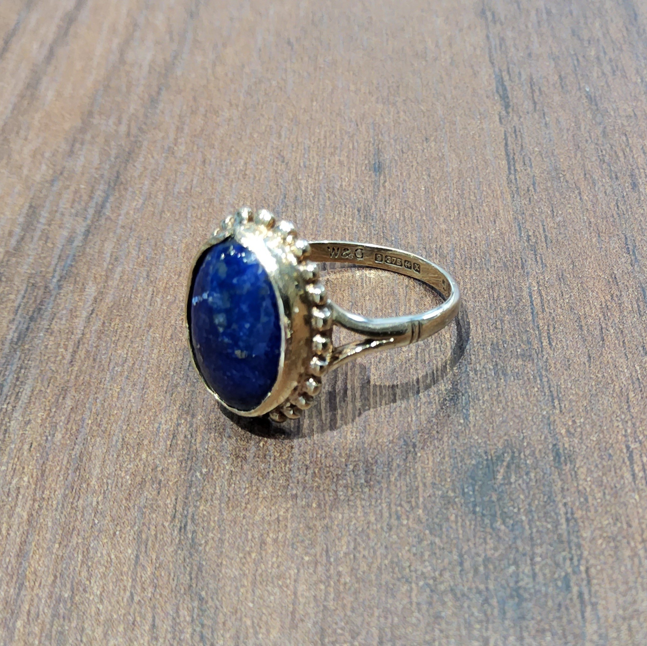 A 9ct gold ring set with an oval Lapis Lazuli stone, size N1/2, 3.1g gross
