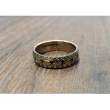 A 9ct gold band, diamond cut with stars & flowers, size J1/2, 2.62g
