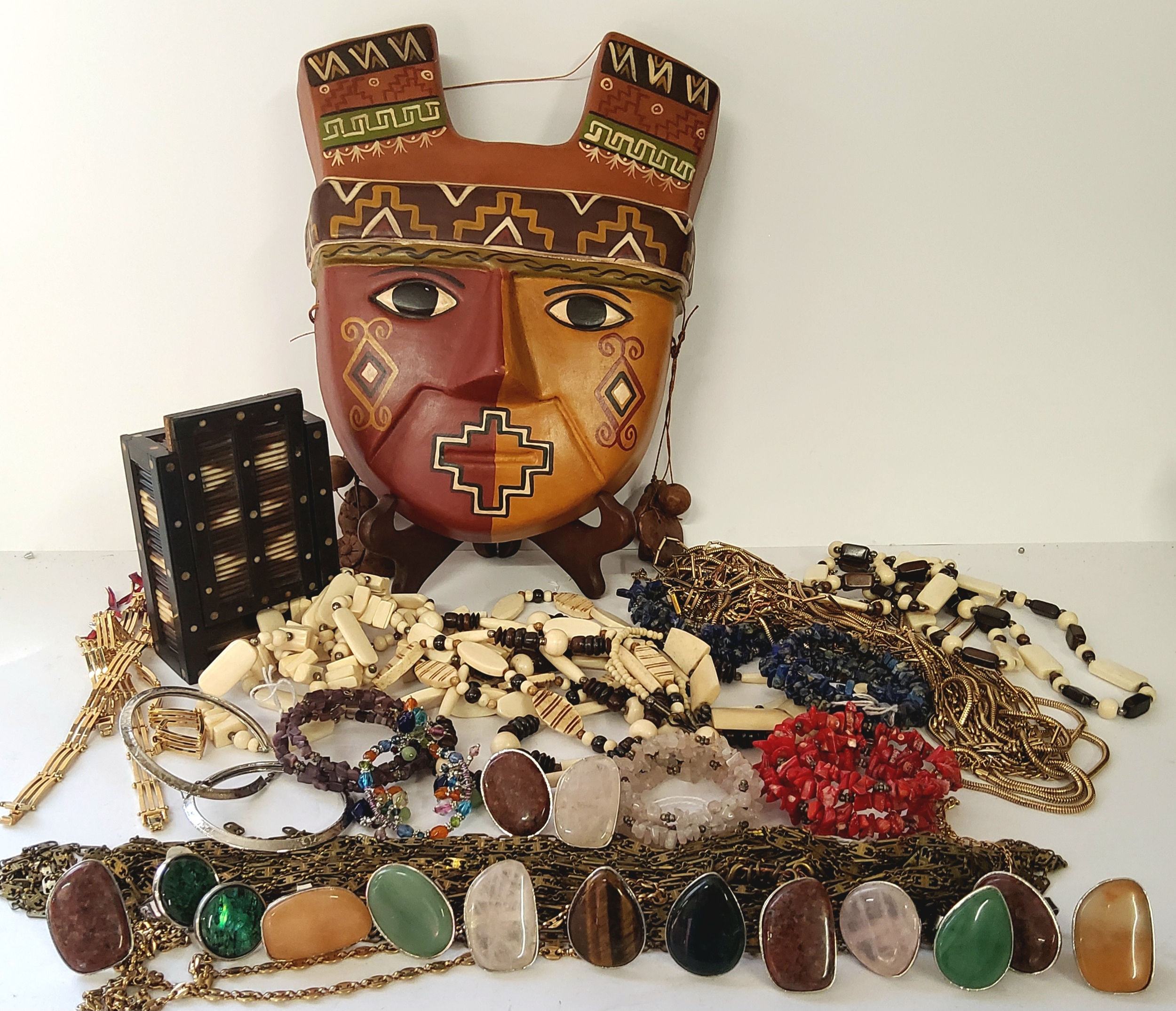 A porcupine quill box, Pre Columbian type mask, birthstone rings, gold plated bracelets, stone