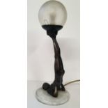 An Art Deco type bronzed table lamp, with gymnastic pose column, frosted globe shade.