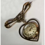 A Merit sweetheart gilt metal fob watch, the watch case contained in a heart shaped drop, 15 jewel