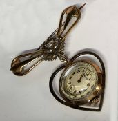 A Merit sweetheart gilt metal fob watch, the watch case contained in a heart shaped drop, 15 jewel
