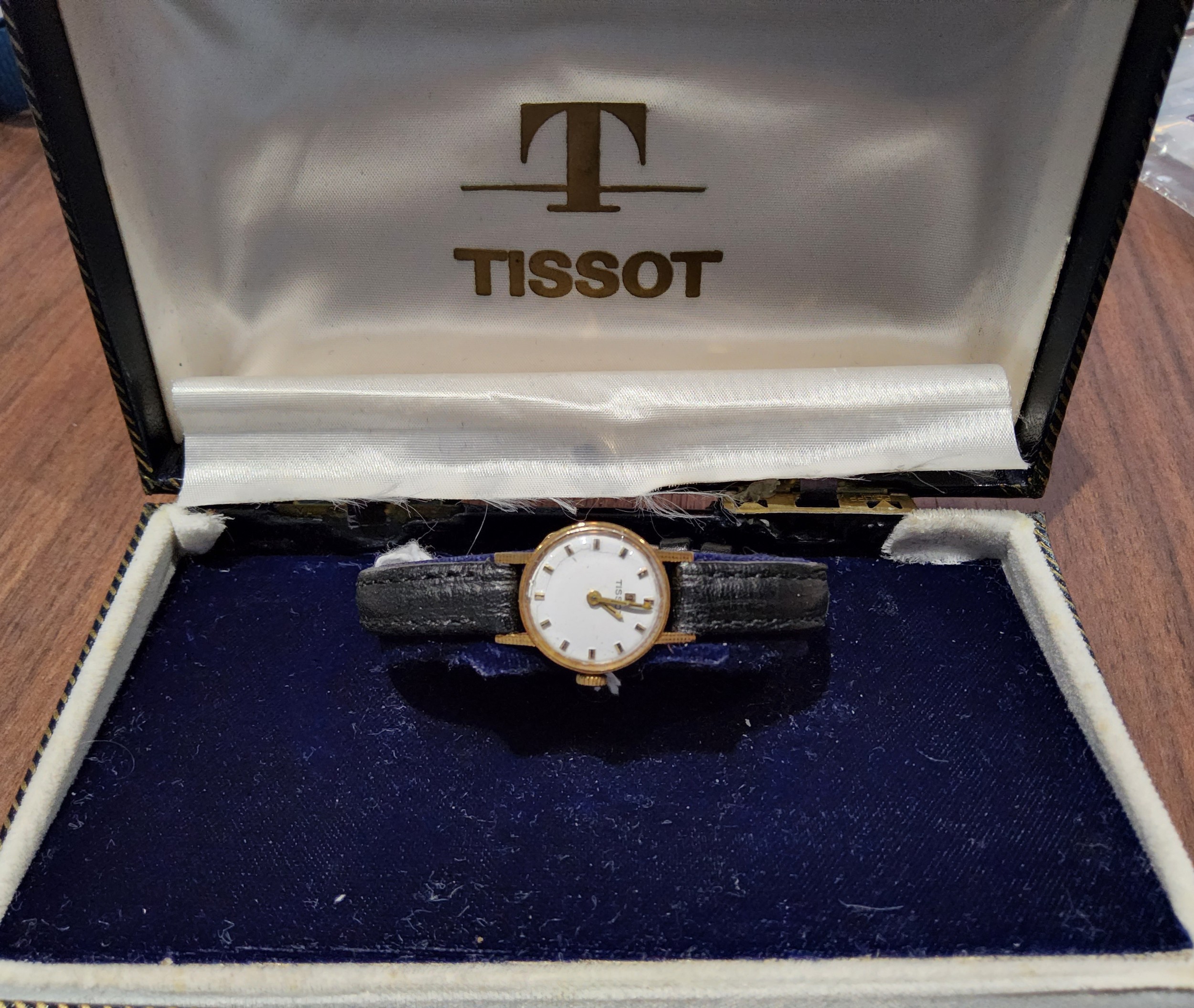 An 18ct gold lady's Tissot watch, Swiss movment, silver dial, gold & black batons, later black