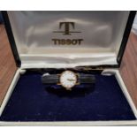 An 18ct gold lady's Tissot watch, Swiss movment, silver dial, gold & black batons, later black