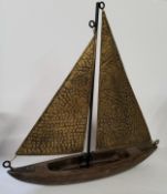 A vintage hand beaten brass and wood yacht model. approx 50cm high.