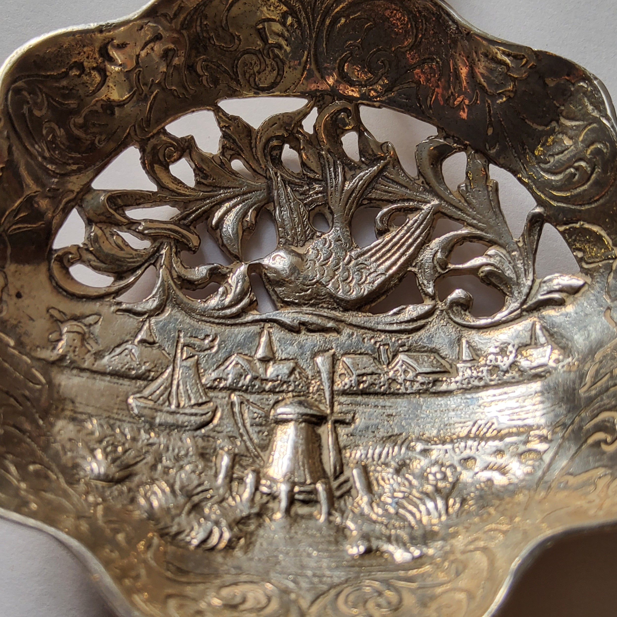 A Dutch silver wet fruit/sifter spoon, the bowl chased, engraved & embossed in relief typical - Image 4 of 4