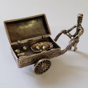 A Dutch silver miniature of a baker & street cart, the hinged lid surmounted with a sign engraved