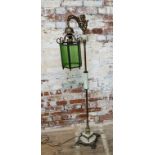 An unusual mid 20th century brass and milk glass standard lamp, the twisted column supporting a