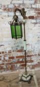 An unusual mid 20th century brass and milk glass standard lamp, the twisted column supporting a