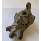 A Roman military clay oil lamp depicting the mask of Pan with small pierced loop handle, pouring