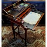 An Edwardian campaign style mahogany writing desk, the hinged rectangular top with sliding mechanism