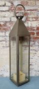 A large stainless steel / glass Moroccan style storm lantern 114cm heigh x 22.5cm wide x 22.5cm deep