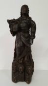 An early 17th century Continental carved Saint figure raised on three cherubs to base. 40cm high