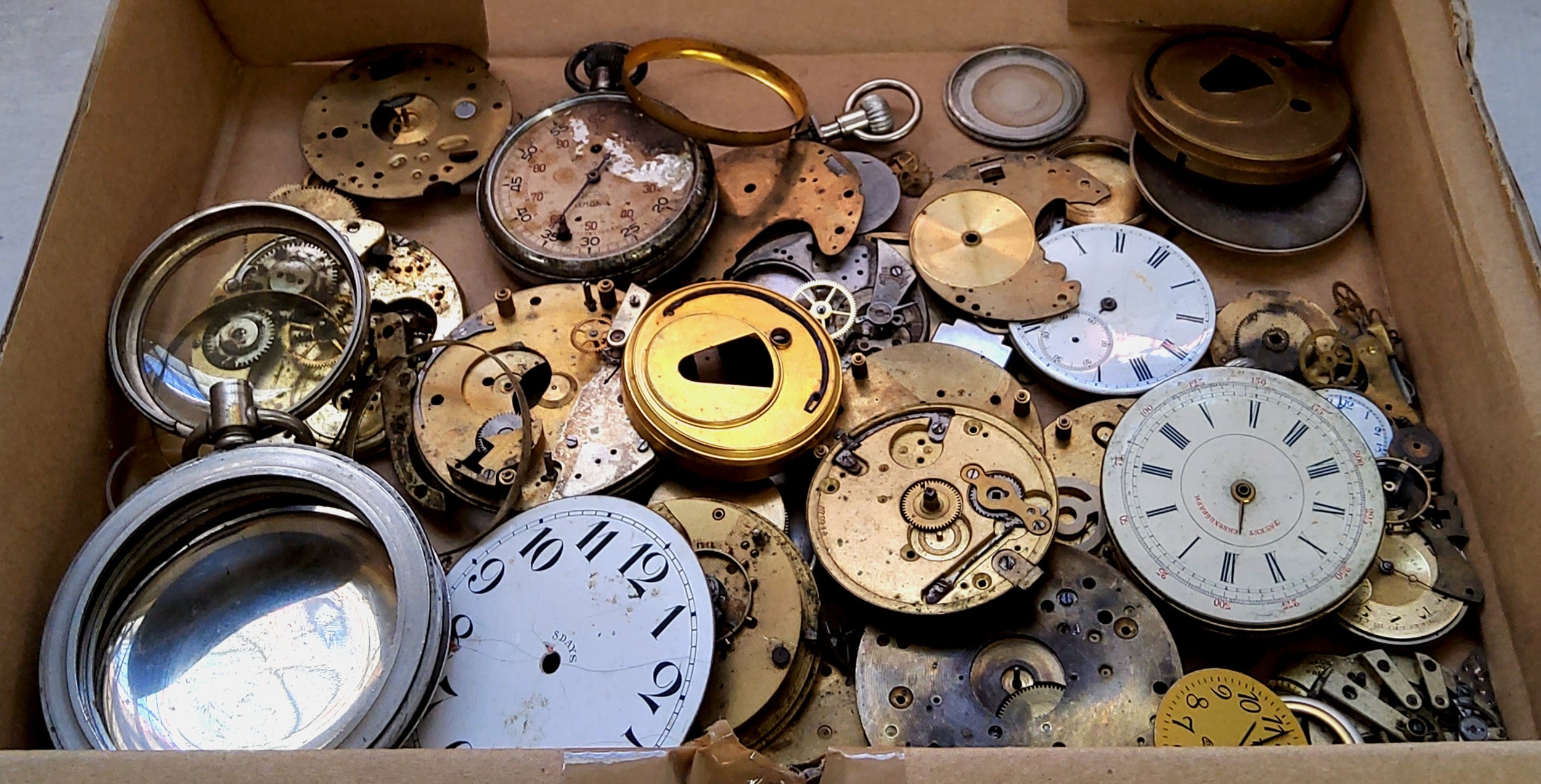 Horology - Various 19th century and later pocket watch parts including cogs, dials and repair parts.