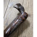 Oriental - an early Japanese walking cane carved with a bearded elder and golden eagle mask pommel