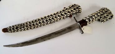 Tribal Interest - a 19th century North African cowrie shell fighting dagger in sheath.