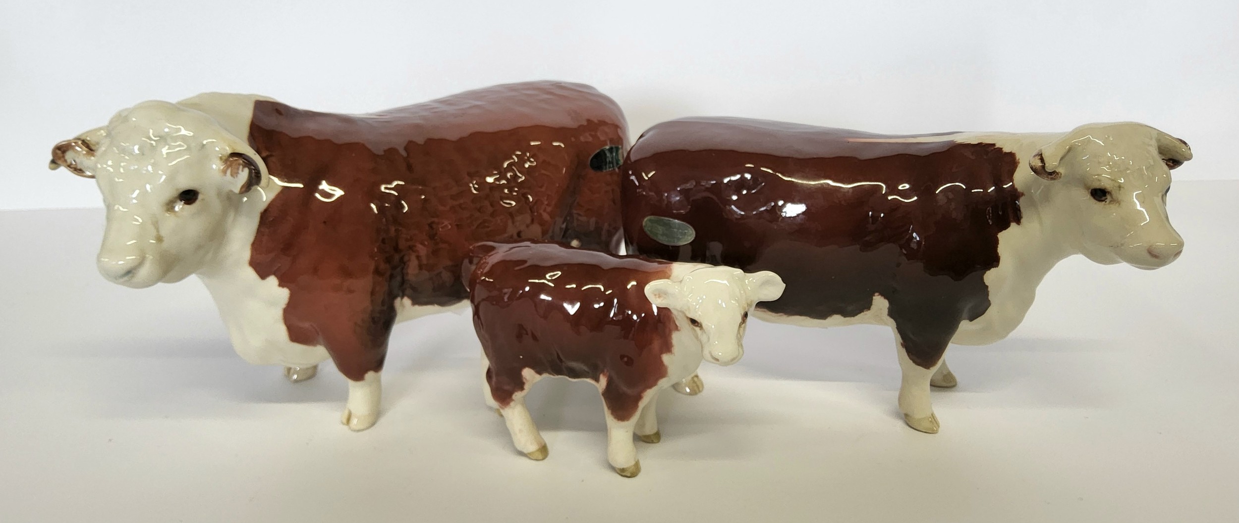 Beswick Hereford bull & cow, both CH of Champions and calf (3)