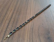 A 9ct gold mystic topaz tennis bracelet 14.18g gross