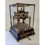 A Congreve rolling ball clock, three white enamelled chapter rings, black Arabic numerals, the fusee