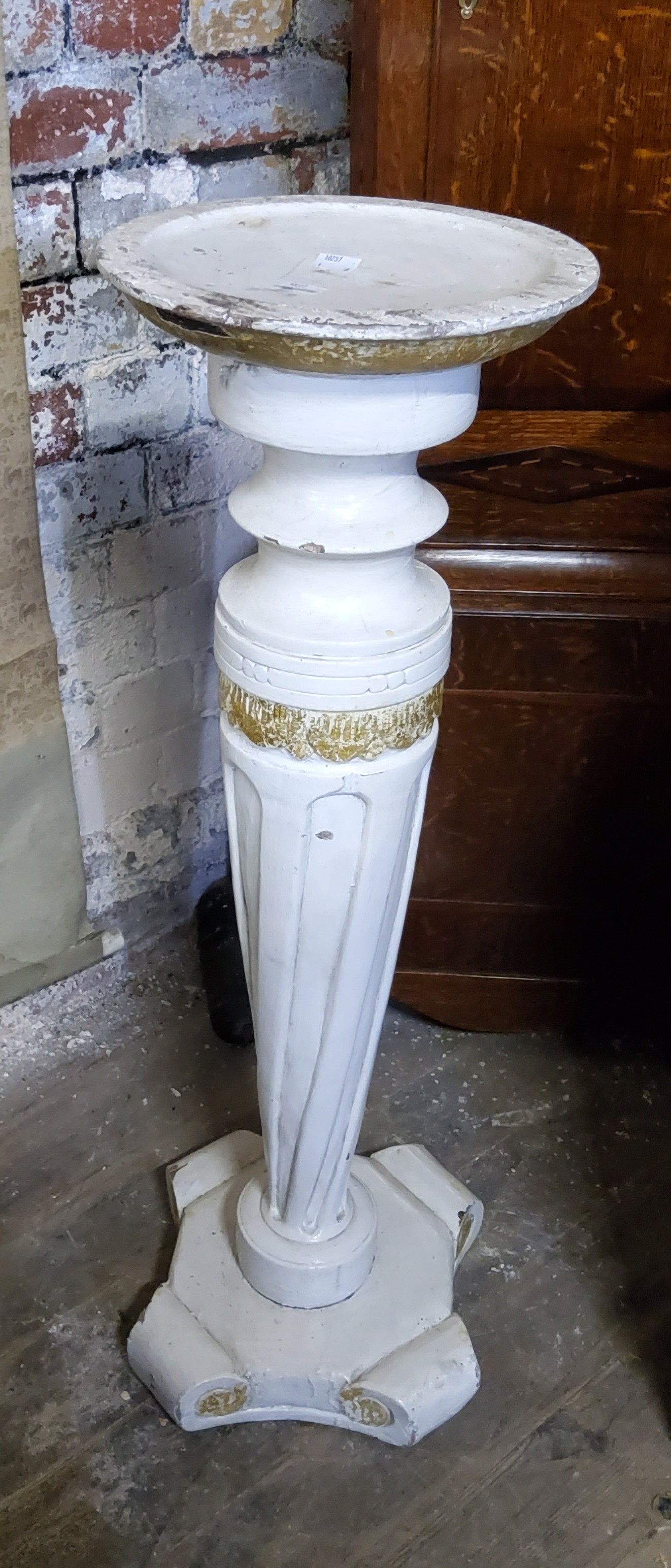 A carved and painted jardiniere stand, with a turned and wrythern twisted tapering support, plinth