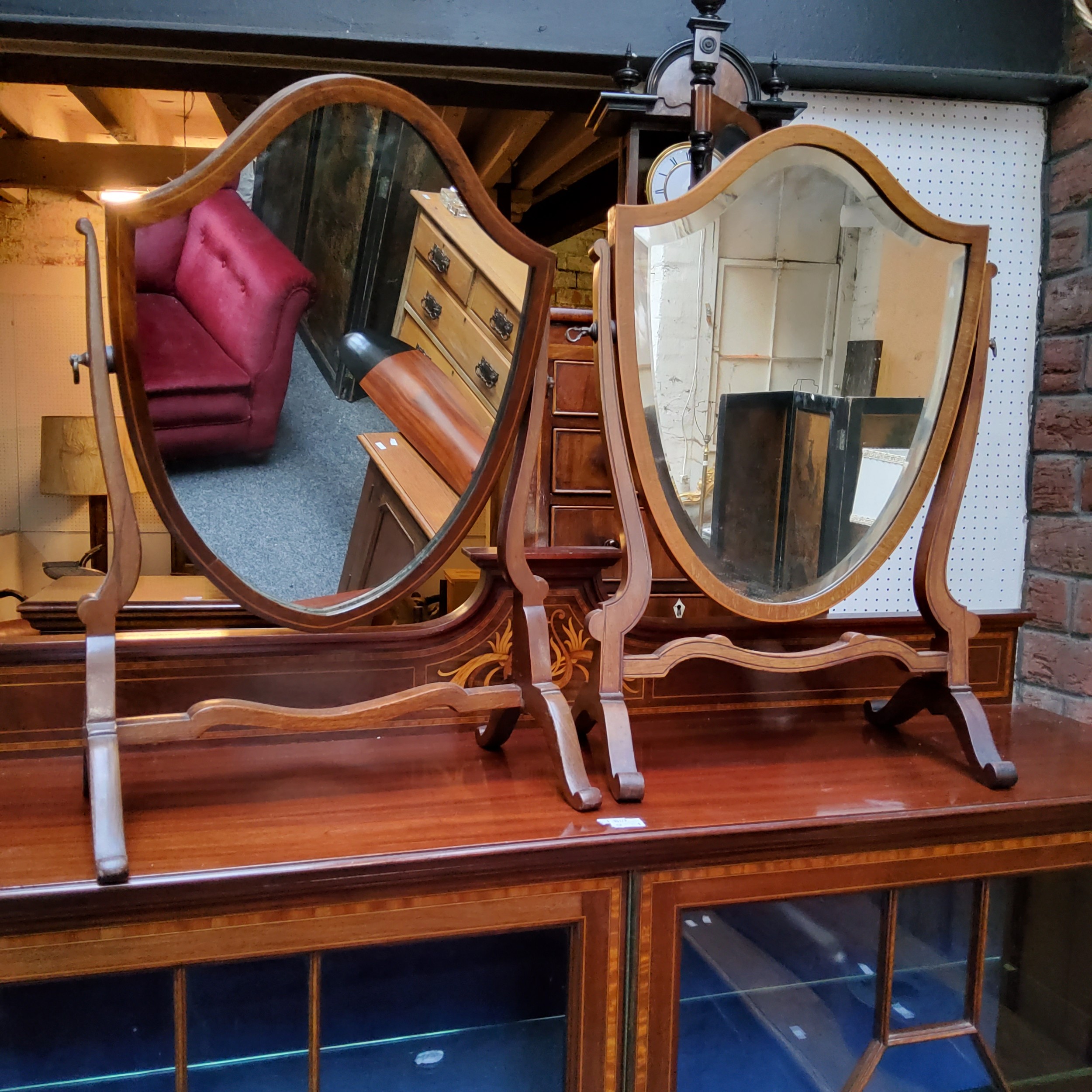 A Sheraton Revival mahogany shield shaped dressing mirror, 58cm high;  another (2)